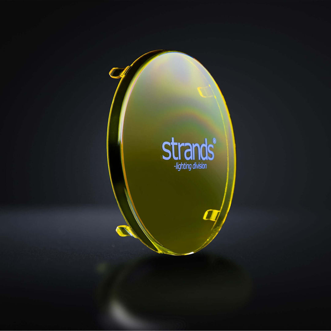 Angled view of a yellow polycarbonate lens cover with strands logo