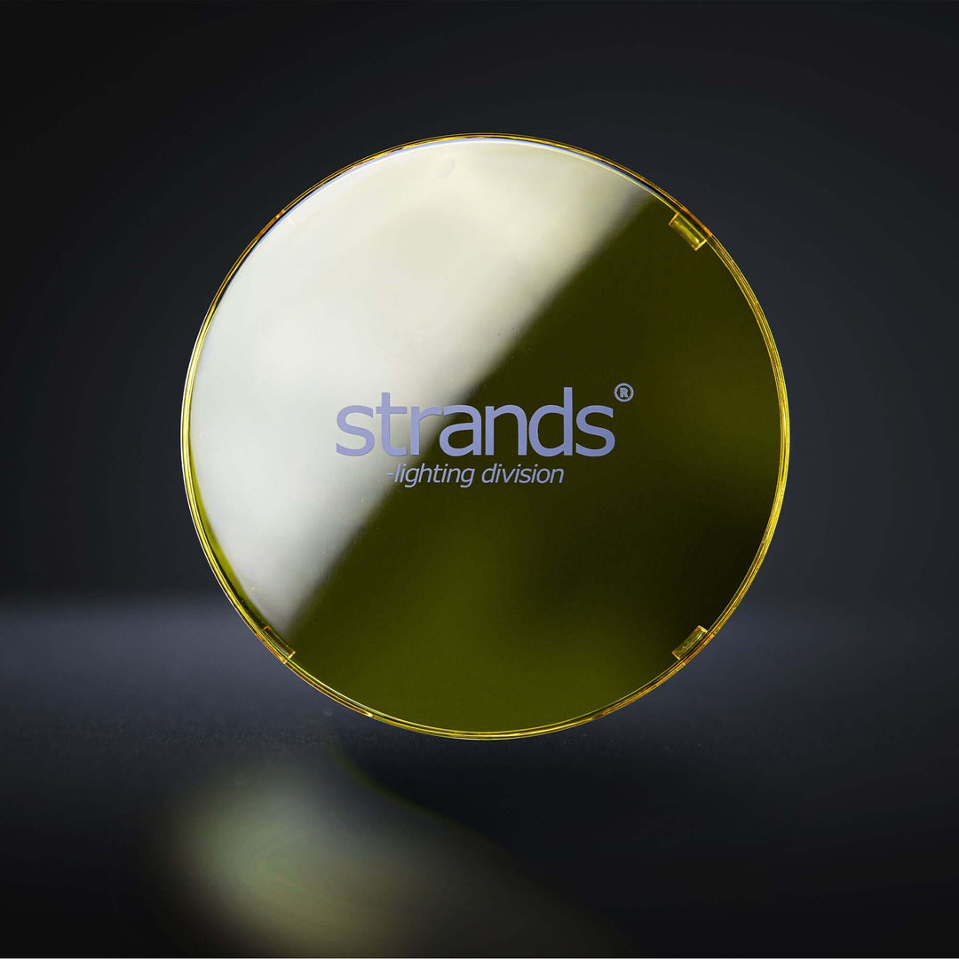Front view of a yellow polycarbonate lens cover with strands logo