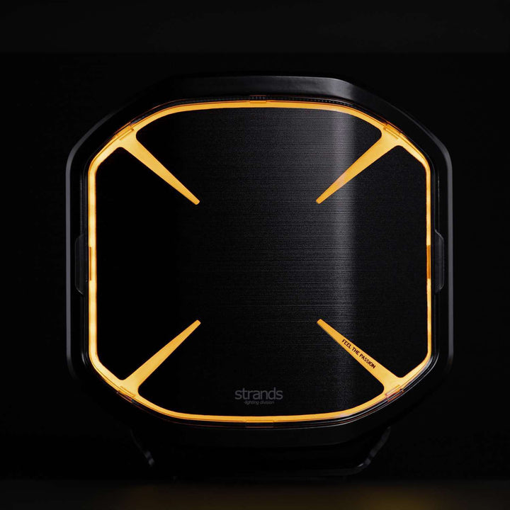Siberia X 7-inch light with black lens cover illuminated, X-shaped amber position light visible